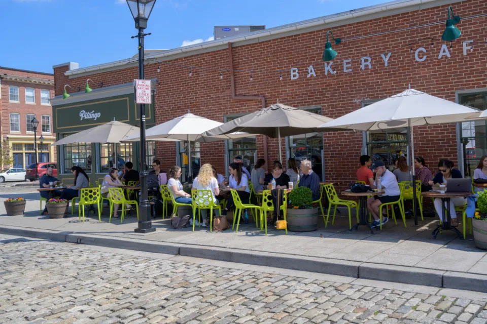 Outdoor dining with bright green chairs on a sidewalk in Baltimore, Maryland